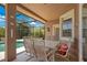Inviting covered patio with outdoor dining set, perfect for relaxing by the screened pool area at 4047 Lillian Hall Ln, Orlando, FL 32812