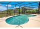Sparkling in-ground pool surrounded by a screened enclosure, providing a private backyard retreat at 4047 Lillian Hall Ln, Orlando, FL 32812