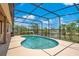 Screened-in pool area with an in-ground pool and beautiful views of the water and sky at 4047 Lillian Hall Ln, Orlando, FL 32812