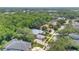 Aerial view of the property nestled in a wooded neighborhood near a scenic lake at 4052 Gilder Rose Pl, Winter Park, FL 32792