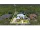Stunning aerial view of a custom home with lush landscaping and a luxurious tiled roof, surrounded by mature trees at 4052 Gilder Rose Pl, Winter Park, FL 32792