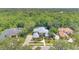 Aerial view of home showcasing lush landscaping, screened pool, and proximity to wooded areas at 4052 Gilder Rose Pl, Winter Park, FL 32792