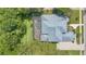 Aerial view of the home featuring a screened lanai and lush greenery at 4052 Gilder Rose Pl, Winter Park, FL 32792
