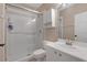 Bright bathroom featuring a glass-enclosed shower, white vanity, and cabinet for storage at 4052 Gilder Rose Pl, Winter Park, FL 32792