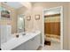 Bathroom featuring a vanity sink, mirror, and a shower with a curtain at 4052 Gilder Rose Pl, Winter Park, FL 32792