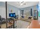 Cozy bedroom with a comfortable couch, desk with dual monitors, and a ceiling fan at 4052 Gilder Rose Pl, Winter Park, FL 32792