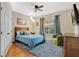 Well-lit bedroom with a ceiling fan, a comfortable bed, and a large window with natural light at 4052 Gilder Rose Pl, Winter Park, FL 32792