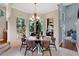 Cozy breakfast nook with large windows overlooking the yard, featuring a chandelier and dining table at 4052 Gilder Rose Pl, Winter Park, FL 32792