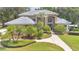 Beautiful two story home featuring a blue tiled roof, green lawn, and well maintained landscaping at 4052 Gilder Rose Pl, Winter Park, FL 32792