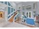 Bright and spacious foyer with a grand staircase, soaring ceilings, and large windows overlooking the backyard at 4052 Gilder Rose Pl, Winter Park, FL 32792