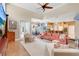 Open-concept living room featuring high ceilings, hardwood floors, and an adjacent kitchen and dining area at 4052 Gilder Rose Pl, Winter Park, FL 32792