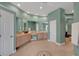 Spacious main bathroom with double vanity sinks, ample storage, tile floor, and modern fixtures at 4052 Gilder Rose Pl, Winter Park, FL 32792