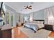 Comfortable main bedroom with a ceiling fan, a king bed, outdoor access, and ensuite bathroom at 4052 Gilder Rose Pl, Winter Park, FL 32792