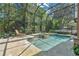 Beautiful pool area featuring a waterfall feature, spa, and lush greenery with an enclosure at 4052 Gilder Rose Pl, Winter Park, FL 32792