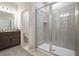 Bright bathroom featuring a glass-enclosed shower and a granite vanity with modern fixtures at 4125 Lavender Ct, Lake Hamilton, FL 33851