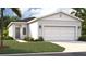 Charming one-story home featuring a well-maintained lawn, a two-car garage, and a modern design at 4125 Lavender Ct, Lake Hamilton, FL 33851