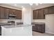 Modern kitchen featuring granite countertops, stainless-steel appliances, and sleek, dark-stained cabinetry at 4125 Lavender Ct, Lake Hamilton, FL 33851
