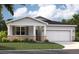 Charming single-story home with stone accents, a two-car garage, and a beautifully landscaped front yard at 4136 Lavender Ct, Lake Hamilton, FL 33851