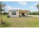 Inviting backyard featuring a covered patio area, perfect for outdoor relaxation and entertaining at 4140 Lavender Ct, Lake Hamilton, FL 33851