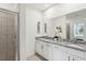 Bright bathroom featuring double vanity with granite countertop, tile floors, and glass enclosed shower at 4140 Lavender Ct, Lake Hamilton, FL 33851