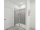 Modern bathroom boasting tile shower with glass door and white door with brushed nickel hardware at 4140 Lavender Ct, Lake Hamilton, FL 33851