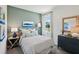 Coastal-style bedroom with striped bedding, dresser, lamps, and a large window with natural light at 4140 Lavender Ct, Lake Hamilton, FL 33851