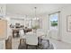 Dining area view with natural light and modern chandelier, open to the kitchen with bar seating at 4140 Lavender Ct, Lake Hamilton, FL 33851