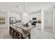 Modern kitchen with granite island, stainless steel appliances, white cabinets, and bar seating at 4140 Lavender Ct, Lake Hamilton, FL 33851