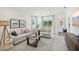 Bright living room featuring neutral furniture, stylish decor, large windows, and an open layout at 4140 Lavender Ct, Lake Hamilton, FL 33851