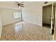 An empty bedroom with tile floors, a ceiling fan, and a window at 5269 Vineland Rd # 101, Orlando, FL 32811