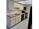 Traditional kitchen with white cabinets and black appliances at 5269 Vineland Rd # 101, Orlando, FL 32811