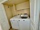 A laundry room featuring a washer and dryer with shelving above at 5269 Vineland Rd # 101, Orlando, FL 32811