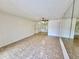 Open-concept living room with mirrors, tile flooring and ceiling fan at 5269 Vineland Rd # 101, Orlando, FL 32811
