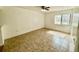 A bright living room with tile floors, a ceiling fan, and a large window at 5269 Vineland Rd # 101, Orlando, FL 32811