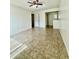 An open living room featuring tile floors and a ceiling fan at 5269 Vineland Rd # 101, Orlando, FL 32811