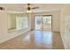 Living room with ceiling fan, mirror wall, and sliding glass doors to outside at 5269 Vineland Rd # 101, Orlando, FL 32811