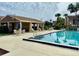 Relaxing community pool with shaded seating area and clear blue water at 5269 Vineland Rd # 101, Orlando, FL 32811