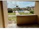 A community pool view from a covered patio with grass and a fence at 5269 Vineland Rd # 101, Orlando, FL 32811