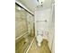 A shower with glass doors and marble tile walls at 5269 Vineland Rd # 101, Orlando, FL 32811