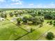 Aerial view showcasing the sprawling property with lush greenery, trees, and well-maintained equestrian facilities at 5478 Nw 153Rd Ct, Morriston, FL 32668