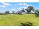 Large backyard with mature trees, fencing, and spacious lawn with covered patio at 5478 Nw 153Rd Ct, Morriston, FL 32668