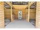 Barn interior featuring wooden stalls and an entrance with a door and 