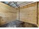 Inside view of a wooden barn stall with metal hardware and dark rubber floor at 5478 Nw 153Rd Ct, Morriston, FL 32668