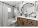 Well-lit bathroom with modern vanity, stylish mirror, and updated shower-tub combination at 5478 Nw 153Rd Ct, Morriston, FL 32668