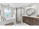 Stylish bathroom featuring a modern bathtub, geometric-patterned shower, and unique tile flooring at 5478 Nw 153Rd Ct, Morriston, FL 32668