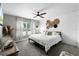 Stylish bedroom featuring a ceiling fan and a bed with decorative pillows and woven wall decor at 5478 Nw 153Rd Ct, Morriston, FL 32668