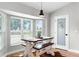 Sunlit breakfast nook with farmhouse table, bench seating, and large windows offering serene views at 5478 Nw 153Rd Ct, Morriston, FL 32668