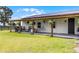 Inviting covered patio with comfortable seating, including rocking chairs, a hammock, and string lights for outdoor relaxation at 5478 Nw 153Rd Ct, Morriston, FL 32668