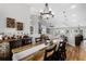 Open-concept dining area adjacent to a living space, showcasing modern décor, stylish lighting, and hardwood flooring at 5478 Nw 153Rd Ct, Morriston, FL 32668