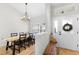 A well-lit dining area features a rustic wooden table, modern chandelier, and a welcoming ambiance for gatherings at 5478 Nw 153Rd Ct, Morriston, FL 32668